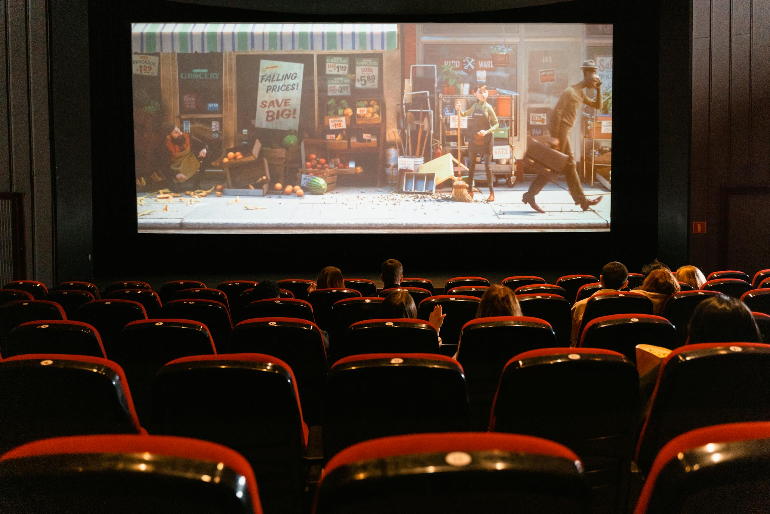 A cozy indoor movie theater showing an animated film to a small audience.