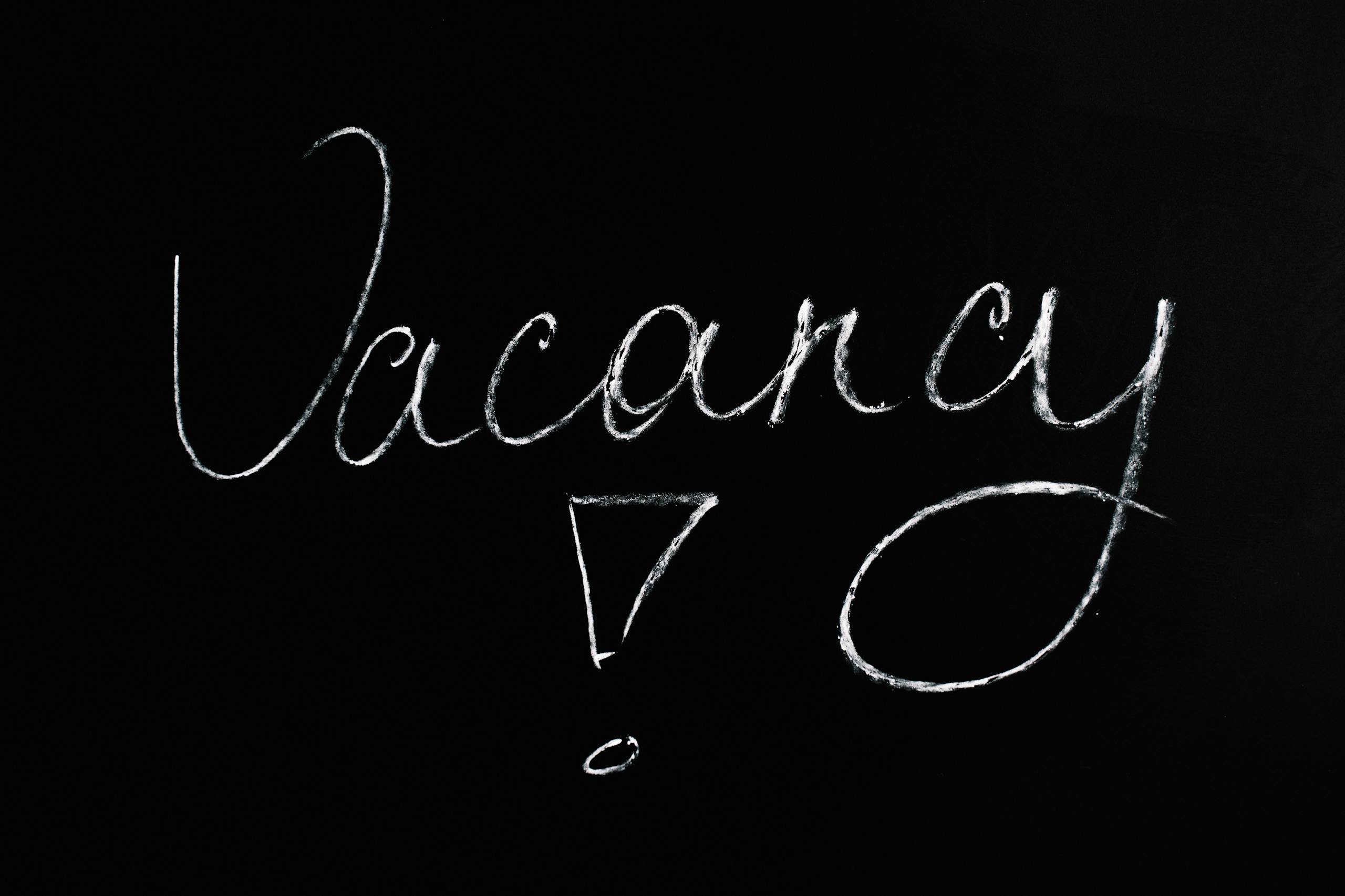 Chalkboard with the word 'Vacancy' written in white on a black background.