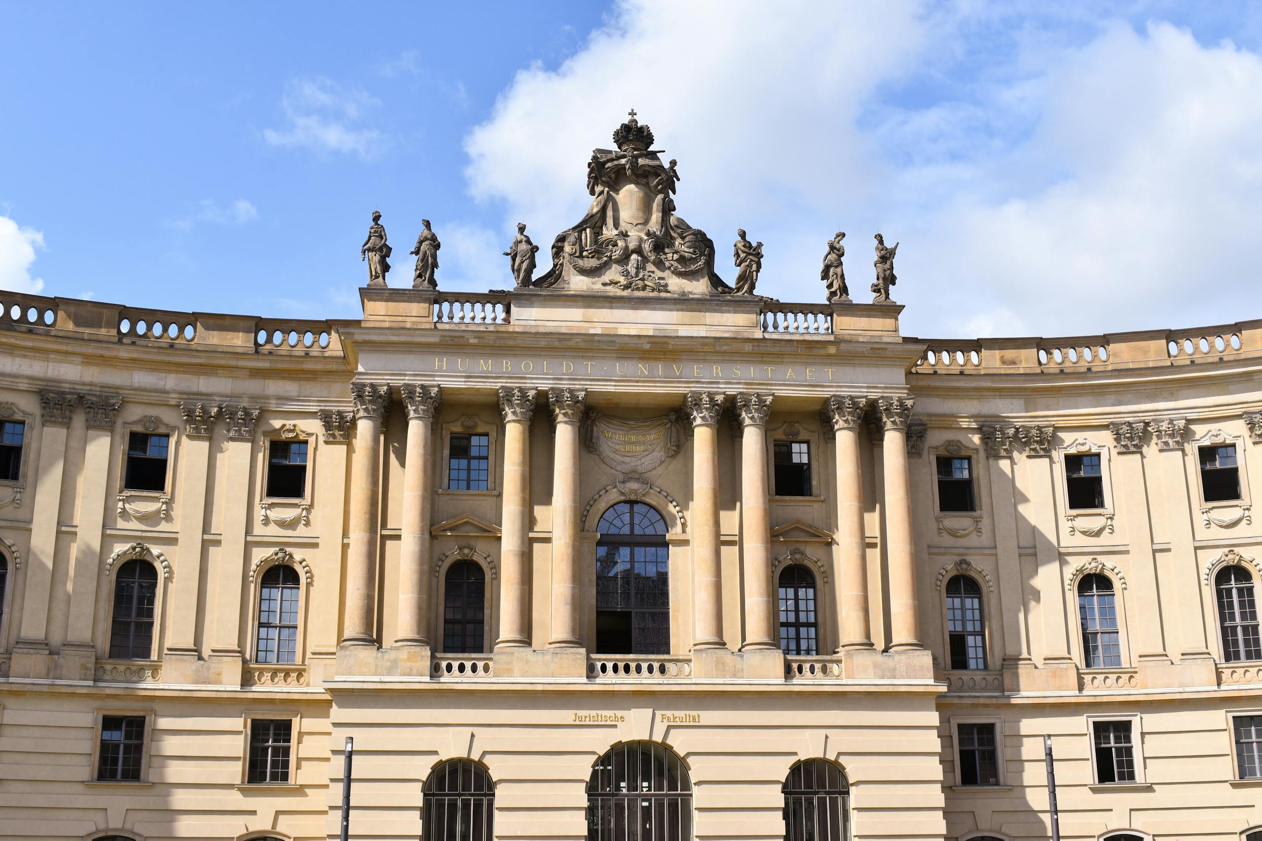 Facade of Humboldt University in Berlin showcasing neoclassical architecture and sculptures.